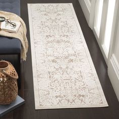 a large white rug sitting on top of a wooden floor next to a blue chair