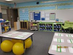 an empty classroom with desks and yellow balls