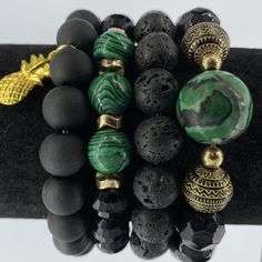 Southern Charmed Stack Bracelets are proudly handcrafted by a Florida educator.  This set features green malachite, black lava stone, and black matte and iridescent glass Czech beads on elastic cord, easily fitting wrists 6-8 inches (may be customized for other lengths--please leave note in comments when purchasing). Luxury Festive Beads For Gifts, Bracelets Layered, Lava Stone Jewelry, African Beaded Bracelets, Beads Gifts, Stack Bracelets, Green Beaded Bracelets, Trending Bracelets