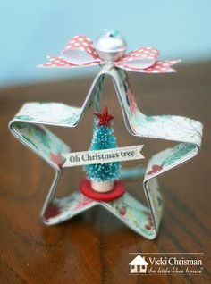 an ornament shaped like a star with a christmas tree on it