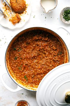 a large pot filled with food next to other dishes