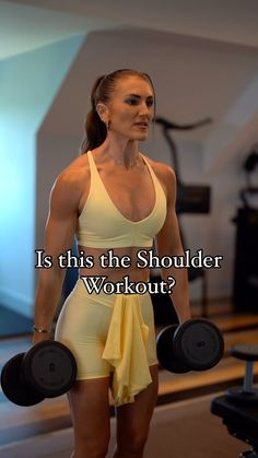 a woman holding two dumbs in her hand and the words is this the shoulder workout?