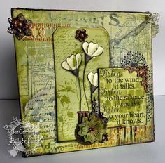 a close up of a card with flowers and words on the front, in green