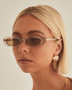 Keep your cool this season in the sleek Poly Sunglasses in Coffee Sheer! You'll find yourself grabbing these for any occasion. These 90's inspired narrow frames are the perfect statement to elevate your look. Composition and Fit: Gold embossed Banbé logo on outer left arm Style details printed in gold foil on inner right arm Lightweight Scratch resistant/Category 3/Polarised 100% UV protection with high sun glare reduction Includes branded vegan case & cleaning cloth Designed in Australia Width: High Fashion Runway, Prism Boutique, Glam Metal, Rectangular Sunglasses, Cool Sunglasses, Oval Sunglasses, 90s Inspired, Eyewear Womens, Swim Fashion