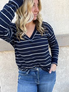 Expertly designed for ultimate comfort and style, our Simple Stripes Top features a flattering V neckline, elongating drop shoulders, and extended cuffs. The ribbed detail adds a touch of texture, while the classic navy and striped pattern make for a versatile and timeless piece. Elevate your wardrobe with this woven top. Striped Relaxed Fit V-neck Blouse, Stripes Top, Striped Stretch V-neck Top, Elevated Basics, Just Peachy, Woven Top, V Neckline, Swim Accessories, Pattern Making