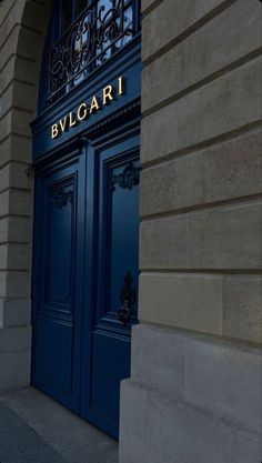 the entrance to an elegant building with blue doors