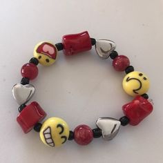 Fun Red & Yellow Emoji & Heart Beaded Bracelet On Stretch Cord, Laser Sealed. Handmade Casual Red Beaded Friendship Bracelets, Handmade Red Beaded Bracelets, Cute Red Stretch Bracelet For Friendship, Cute Red Stretch Bracelet Gift, Cute Red Stretch Bracelet As Gift, Red Stretch Bracelet For Friendship In Trendy Style, Trendy Red Stretch Bracelet For Friendship, Trendy Adjustable Red Stretch Bracelet, Trendy Red Adjustable Stretch Bracelet