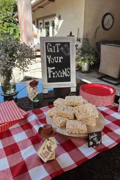 a table topped with lots of desserts on top of a red and white checkered table cloth