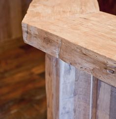 a close up of a wooden bench with nails on the top and bottom part of it