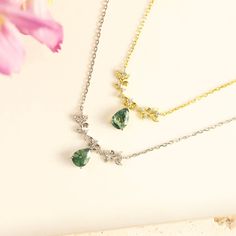 Step into a world where nature's whispers come alive with our Foliage Whispers Moss Agate Necklace. It showcases a pear-shaped moss agate pendant delicately hanging from whimsical vines adorned with sparkling white topaz stones. Wear this necklace as a reminder to embrace the beauty of the world around you and find serenity in nature's gentle whispers. ✦ 14K Yellow Gold Vermeil (14K yellow gold plated over a sterling silver base) Nature-inspired Gemstone Teardrop Pendant Necklaces, Nature-inspired Teardrop Gemstone Necklace, Nature-inspired Teardrop Gemstone Necklaces, Magical Stones, Lucky Stone, White Gold Necklaces, Topaz Stone, Agate Necklace, Agate Pendant