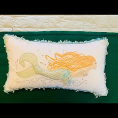 a pillow with an image of a mermaid on it