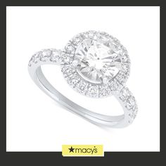 a white gold ring with an oval cut diamond surrounded by round brilliant pave diamonds