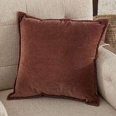 a brown pillow sitting on top of a couch