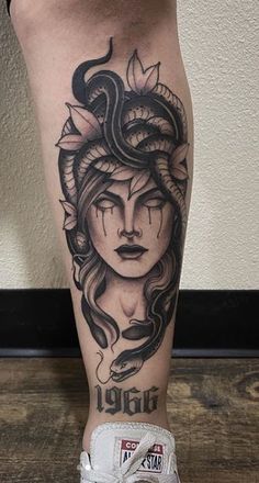 a woman's leg with a tattoo on it and an image of a snake