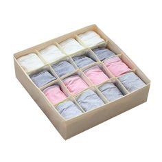 an open box with several pairs of baby socks in it and one pair of mitts on the floor