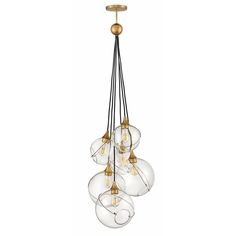 a chandelier with five glass globes hanging from it's brass finish