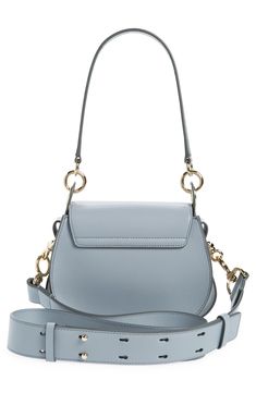 Gleaming pierced-ring hardware highlights the equestrian-inspired silhouette of this calfskin-leather saddle bag. Interchangeable straps for over-the-shoulder or crossbody carry add everyday convenience to the luxe style. Magnetic-snap flap closure Removable top handle; removable, adjustable shoulder/crossbody strap Linen lining Leather Made in Italy Designer Handbags This brand has B Corp certification, representing business practices with emphasis on social and environmental performance, accou Modern Top Handle Shoulder Bag With Horsebit Detail, Modern Shoulder Bag With Horsebit Detail And Top Handle, Office Shoulder Bag With Horsebit Detail And Crossbody Shape, Office Crossbody Shoulder Bag With Horsebit Detail, Luxury Crossbody Shoulder Bag With Horsebit Detail, Evening Saddle Shoulder Bag With Gold-tone Hardware, Luxury Crossbody Saddle Bag With Silver-tone Hardware, Top Handle Shoulder Bag With Horsebit Detail For Office, Office Satchel Shoulder Bag With Horsebit Detail