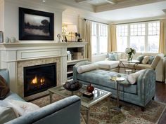 a living room filled with furniture and a fire place in the middle of a room