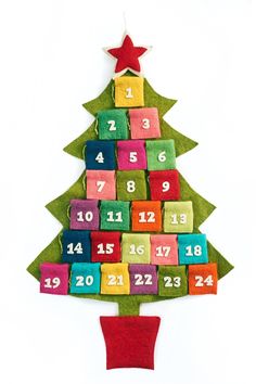 a christmas tree made out of felt blocks with numbers on it and a star hanging from the top