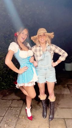 two women dressed in costumes posing for the camera