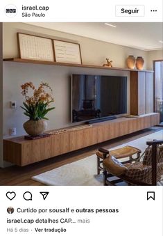 a living room filled with furniture and a flat screen tv on top of a wooden entertainment center