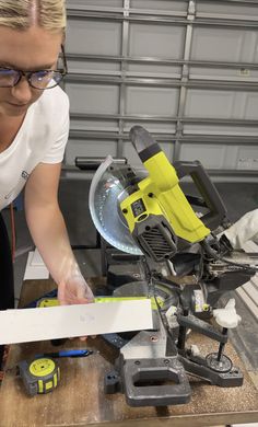 a woman working on a piece of wood with a power plane in front of her