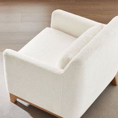 a white chair sitting on top of a hard wood floor