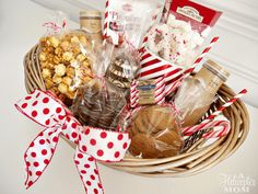 a basket filled with lots of different types of snacks and treats on top of a table