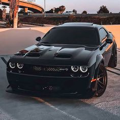 a black sports car parked in a parking lot