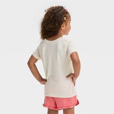 Fill your toddler's day with fun and excitement with this Short-Sleeve Rainbow Graphic T-Shirt from Cat & Jack™. Crafted from lightweight jersey fabric and featuring a tagless design, this short-sleeve T-shirt brings cool comfort to their day, while the below-waist length gives them the option of wearing it tucked in or untucked. Designed in a light beige hue, this crewneck tee features a rainbow graphic adorned with white flowers for cute style. Cat & Jack™: Designed for all children so you can Playtime Soft-washed White Tops, Playful Summer T-shirt For Playdate, Soft-washed Cotton Tops For Playwear, Casual T-shirt For Playdate, Playful Crew Neck Tops For Playdate, Soft-washed Crew Neck Tops For Playtime, Playful Soft-washed Tops For Playtime, Cotton Short Sleeve T-shirt For Playdate, Relaxed Fit Crew Neck Top For Playtime