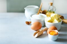 eggs, butter, and other ingredients are on the counter top in small white bowls