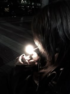 a woman holding a small light in her hand