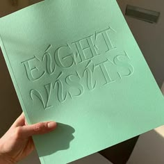 a person holding up a piece of paper with the words eight months written on it