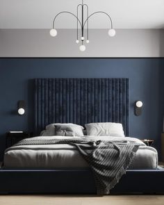 a large bed sitting in the middle of a bedroom next to a wall mounted light