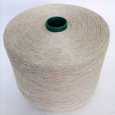 a spool of yarn sitting on top of a white table