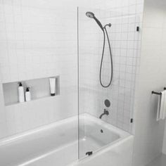 a bathroom with a shower, toilet and bathtub in white tiled floored room