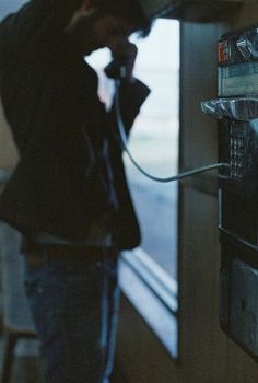 a man is using an old fashioned telephone