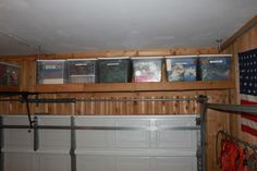 the garage is filled with many different types of storage boxes on top of the shelves