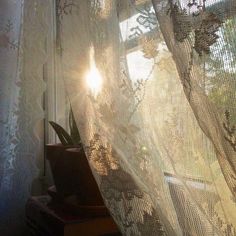 the sun is shining through the sheer curtain