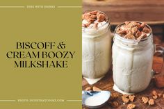 two mason jars filled with ice cream and cereals on top of a wooden table