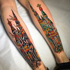 two people with tattoos on their legs and one has a castle in the middle of it