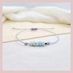 This delicate macrame bracelet in boho style is set with genuine Larimar gemstones. The natural stones are complemented with silver-plated beads and a nylon cord in gray. The practical sliding clasp guarantees optimal wearing comfort. The bracelet fits every wrist and is therefore also perfect as a gift for a loved one 🤍 ℹ️ Larimar is a very rare turquoise-blue gemstone and comes from the Dominican Republic. The color of Larimar varies between white, light blue, green-blue and deep blue. Larima Handmade Adjustable Aquamarine Bracelet, Adjustable Aquamarine Bracelets With Natural Stones, Adjustable Beaded Aquamarine Bracelets, Handmade Silver Amazonite Beaded Bracelets, Adjustable Aquamarine Beaded Bracelets With Natural Stones, Adjustable Aquamarine Beaded Bracelet With Natural Stones, Adjustable Beaded Aquamarine Jewelry, Adjustable Silver Aquamarine Bracelets, Adjustable Silver Aquamarine Bracelet