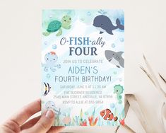 a person holding up a birthday card with an ocean theme