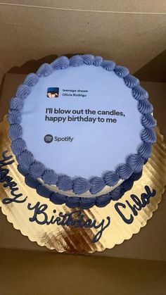 a birthday cake in a box with a message on the top and blue icing