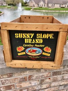 a sign on the side of a brick wall advertising sunny slope brand carolina peaches