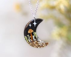 Step into the magic of the enchanted forest with this stunning Cottagecore mushroom necklace, featuring real pressed mushrooms 🍄 and pixie cup lichen 🍃, beautifully preserved in resin. This unique piece of moon jewelry combines the whimsical charm of the forest with the mystical beauty of the night sky 🌙, making it a perfect accessory for those who love nature and fantasy-inspired jewelry. Whether you're a lover of the night sky or enchanted woodlands, this pressed mushroom necklace captures the essence of both, making it a special and meaningful piece. It's ideal for anyone who appreciates Cottagecore style and nature-inspired designs, adding a magical touch to any outfit. 🍄 Our Mushroom Jewelry: https://www.etsy.com/shop/NatureResinJewelry?section_id=51200953 💚 Handmade with love an Pixie Cup Lichen, Sky Necklace, Forest Necklace, Cottagecore Mushroom, Mushroom Necklace, The Enchanted Forest, Mushroom Jewelry, Cottagecore Style, Nature Necklace