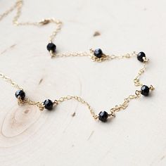 Scattered Spinel Gemstone NecklaceThe most tiny & dainty everyday necklace. Featuring seven tiny black spinel rondelles (~4mm each) that are hand wrapped to the most delicate & shimmering 14k gold fill chain. A gorgeous necklace that you will reach for everyday..Necklace measure 17 inches as pictured. Completed with a round spring clasp. ♥Your purchase will come thoughtfully packaged and ready for gift giving. If this purchase is a gift that we are shipping directly to the recipient, ple Black Spinel Round Beads Jewelry For Gifts, Gift Black Spinel Round Bead Jewelry, Minimalist Black Spinel Necklace As Gift, Delicate Black Necklace For Gift, Gift Necklace With Black Spinel And Beads, Gift Black Spinel Necklace With Black Beads, Black Spinel Beaded Necklace For Gifts, Black Spinel Necklace With Black Beads For Gift, Dainty Jewelry With Black Beads For Gifts