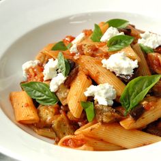 a white bowl filled with pasta and cheese