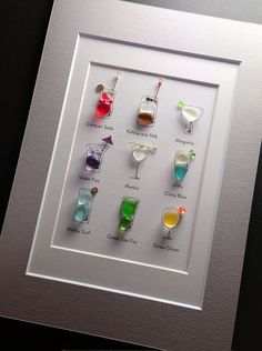 a framed photograph with different colored drinks in it's glasses on the bottom half