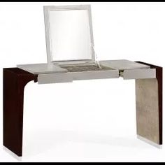 a laptop computer sitting on top of a wooden desk next to a white chair and table